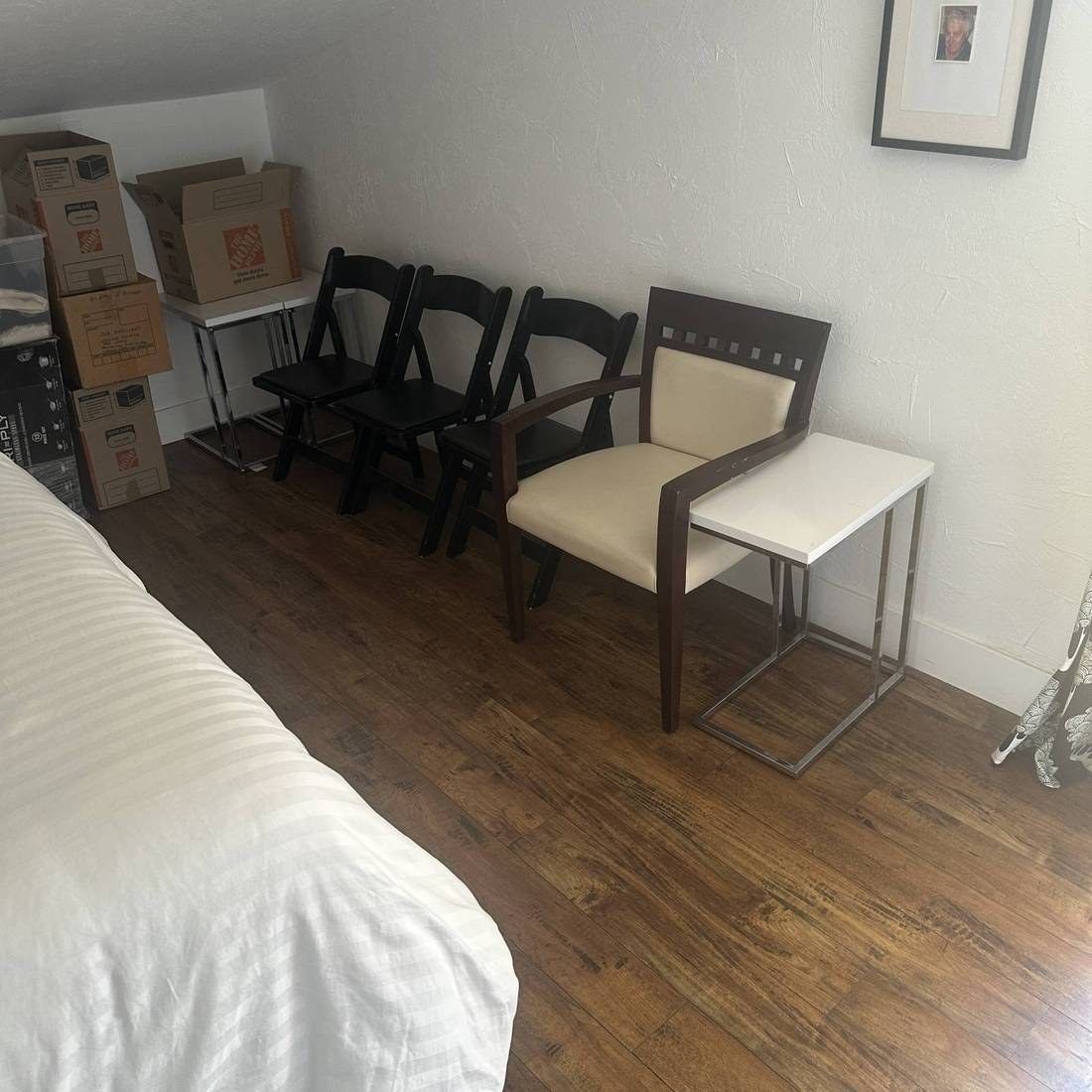 Bedroom with boxes and chairs staged for removal