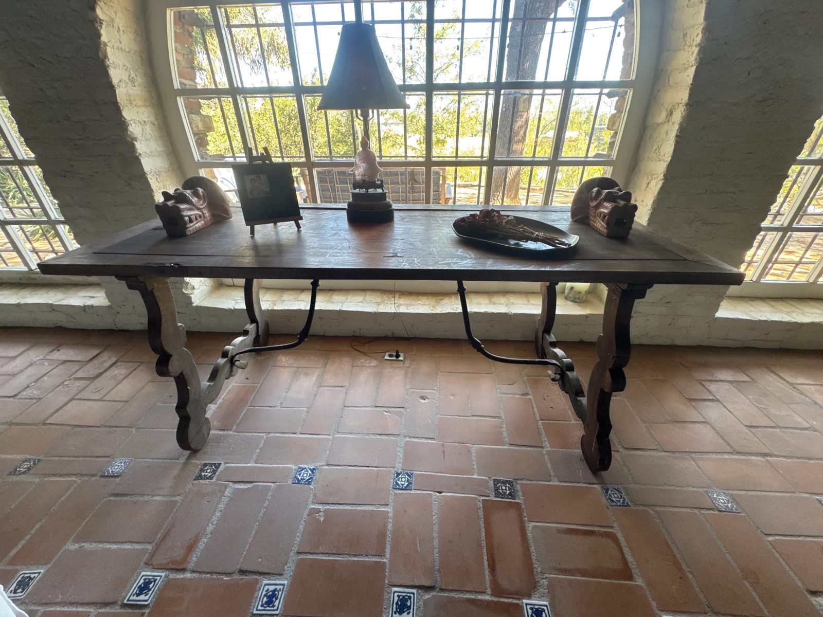 Antique trestle table photographed in the estate's sunroom before auction placement